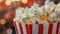 Close up image of a red and white striped popcorn cup