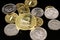 A close up image of Russian Federation coins with a gold South African Krugerrand on a black background