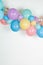 A close up image of a soft pastel balloon garland against a white background