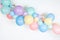 A close up image of a soft pastel balloon garland against a white background