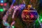 Close up image of sparkling colored glass ball hangs on the Christmas tree.