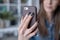 close up image of woman holding phone, video calling, using online mobile chat app