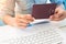 Close up image of woman`s hands holding passport book on work sp