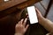 Close-up image of a woman using her smartphone while sitting in a coffee shop. chat, message, apps