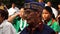 Close up image of World War II male veteran listening to speech during a commemoration event.