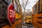 A close up image of yellow American school bus with selective focus on the stop sign on the side