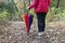 Close up image of young female with closed colorful umbrella in autumn park,