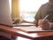 Close up image of young man using laptop technology and Writing Notebook Workplace Concept