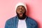 Close-up of impressed Black male model saying wow, staring at camera amazed and wondered, standing over pink background