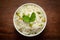 Close-up of Indian Basmati steamed Rice or matar Pea pulao or Pulav garnished with fresh green mint leaf in a ceramic white bowl