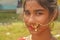 Close up of an Indian Bengali teenage girl wearing Indian traditional jewellery like nose ring, ear rings, red bindi on forehead