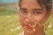 Close up of an Indian Bengali teenage girl wearing Indian traditional jewellery like nose ring, ear rings, red bindi on forehead