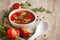 Close-up of Indian Homemade fresh and healthy tomato soup garnished with fresh coriander leaves and ingredients and herbs,