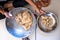 Close up of indian man hands making roti dough in pot with soft natural light with a sense of intimacy and cosy