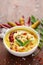 Close-up of Indian traditional kadhi or kadi pakora yogurt and gram flour and turmeric served hot in a clay bowl.