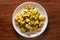 Close-up of Indian vegetarian classic dish Jeera Aloo - Potatoes Flavored with Cumin garnished with green coriander fresh leaves.