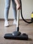 close up individual using vacuum cleaner. High quality photo