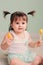 Close up indoor portrait of cute happy baby girl playing with easter decorations