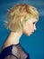 Close-up indoor portrait of lovely girl with blonde hair. Studio shot of graceful young woman with short haircut