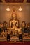 Close up indoor shiny golden buddha statue in buddhist temple in