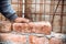 Close up of industrial bricklayer installing bricks on construction site