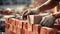 Close up of industrial bricklayer installing bricks on construction site