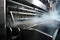 close-up of industrial dishwasher, with cascade of water and steam