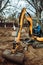 Close up of industrial mini excavator scoop moving earth and doing landscaping works