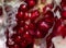 Close-up of the inner contents of a cut pomegranate. Close-up of pomegranate seeds are visible. Background