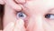 Close up of inserting a contact lens