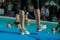 Close-up of Instructor Legs at Swimming Pool Edge: Aqua Aerobics Workout