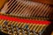 A close-up of the internal string structure of a top grand piano