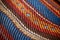 a close-up of intricately woven multicolored mats mkeka