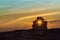 Close-up of Inukshuk stones on ocean shore at sunset