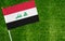 Close-up of Iraq flag against closed up view of grass