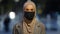 Close-up islamic female in medical mask posing in night city. Muslim business woman wearing hijab masked girl standing