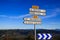 Close  up of isolated direction signs arrow with endless valley against blue sky - Provence, France, Digne les Bains