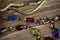 Close up isolated group gold precious jewellery chains and colorful gem bracelet on wood table