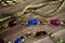 Close up isolated group gold precious jewellery chains and colorful gem bracelet on wood table