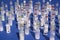 Close up of isolated injection medication glass vials, blue background focus on center