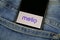 Close up of isolated mobile phone with payment provider Melio logo lettering in jeans pocket