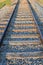 Close up of an isolated railway line with straight railway tracks leading into the distance