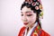 Close-up isolated white background Beijing opera Chinese female actress woman makeup comb hair with traditional headwear costume