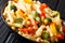 Close-up of Italian vegetarian penne pasta with chickpeas, broccoli, bell pepper and spices in a plate. horizontal