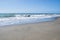 Close up. Italy, Rome, Ostia. Coast of the Tyrrhenian Sea. Seascape. A serene day, blue sky, azure sea rolls its foamy waves