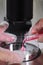 Close-up of the IVF procedure. An embryologist wearing protective gloves drips the medium from a plastic test tube into a Petri