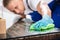 Close-up Of A Janitor Cleaning Desk With Cloth