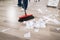 Close-up Of Janitor Sweeping Hardwood Floor