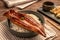 Close-up Japanese grilled eel served over rice or Unagi don set on plate. Japanese food on restaurant table