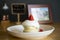 Close-up of Japanese-style pancakes, decorated with plates with fruit faces, strawberries on a wooden table